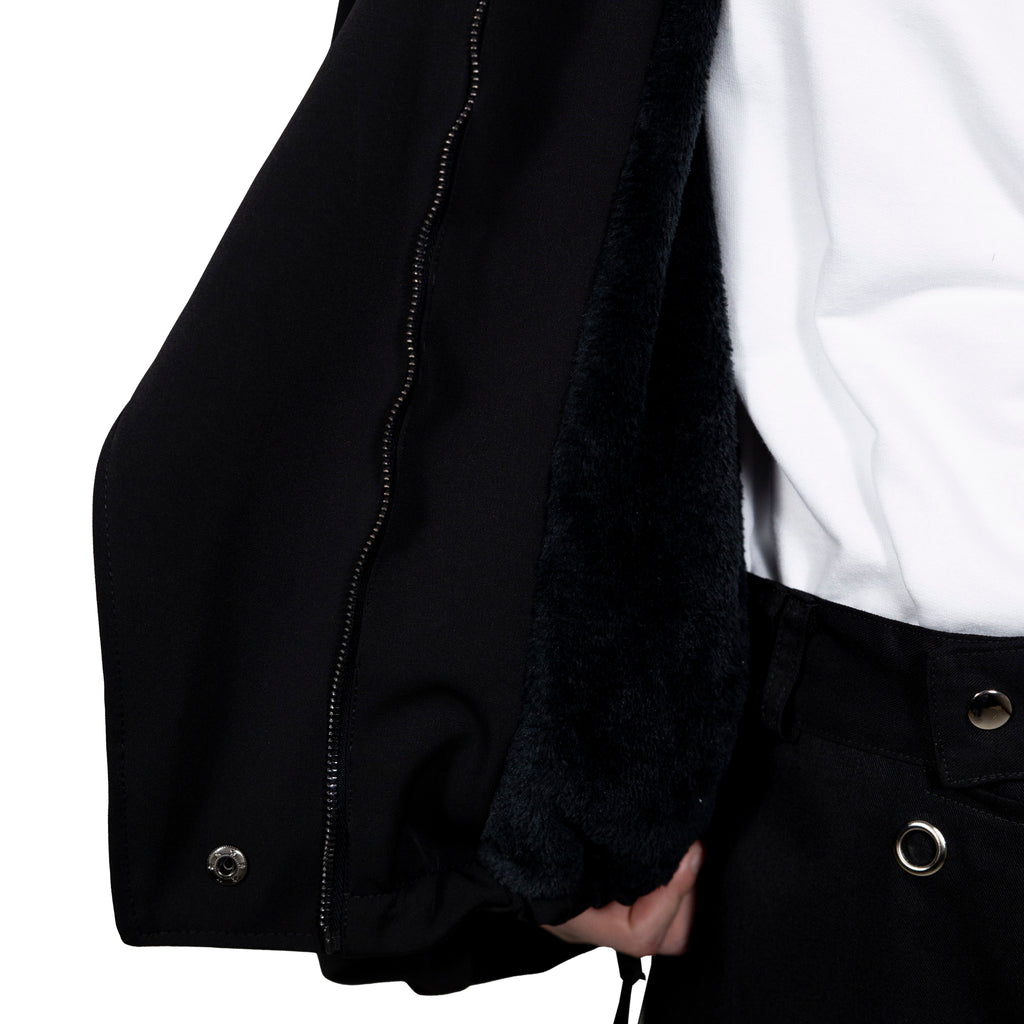 Double layered twill jacket in black. 100% waterproof exterior and fur fleece interior. Folded sleeves and multi-position front.