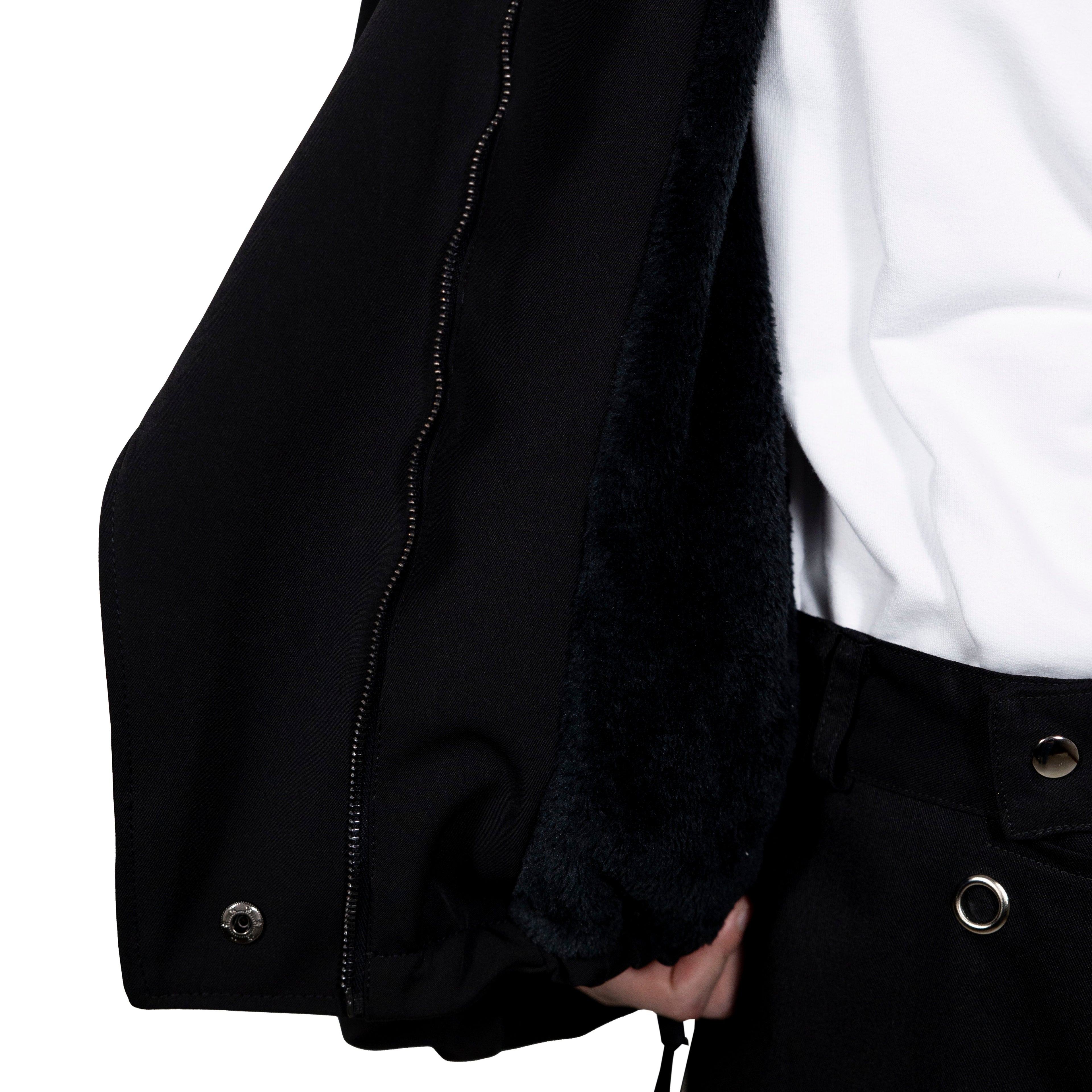 Double layered twill jacket in black. 100% waterproof exterior and fur fleece interior. Folded sleeves and multi-position front.