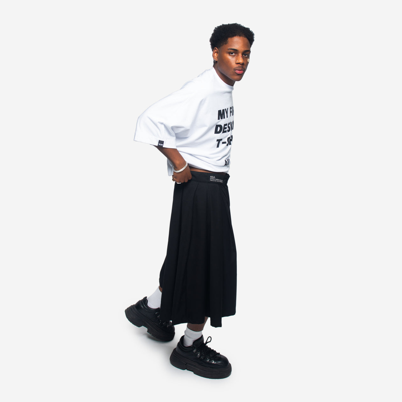 Wide-leg Bermuda shorts with a skirt-like effect, featuring an embroidered belt loop and pockets. They have a zip fastening, a flap closure, and internal drawstrings for waist adjustment.Handmade in Vigo by Aile Brand.